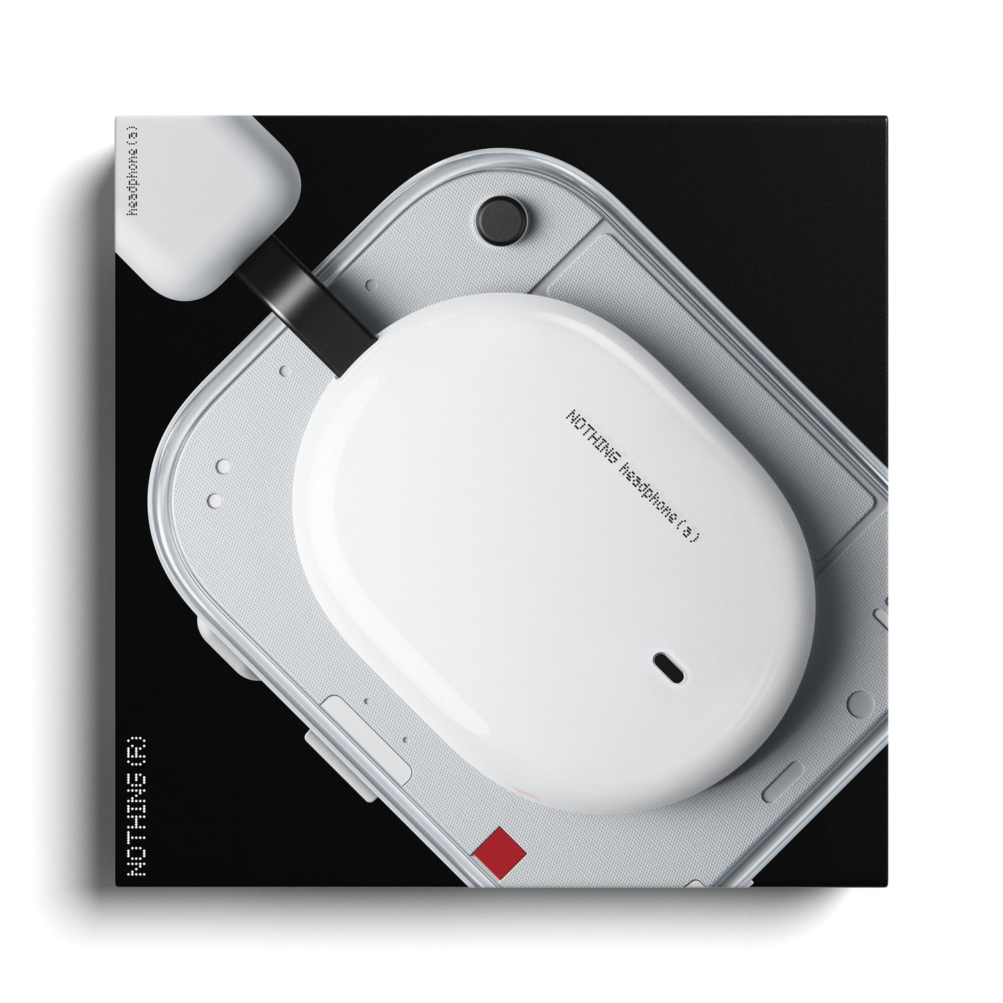 Nothing Headphone (a) hvid trådløs over-ear høretelefoner etui på afrundet hvid enhed med tilsluttet oplader.
