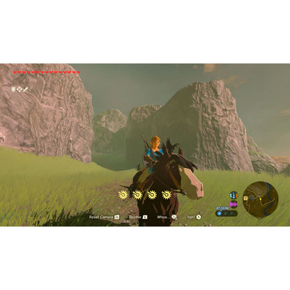 Nintendo Legenden om Zelda: Breath of the Wild Switch 2-udgave, spilscene med hest, dal, klipper og synligt interface/map.