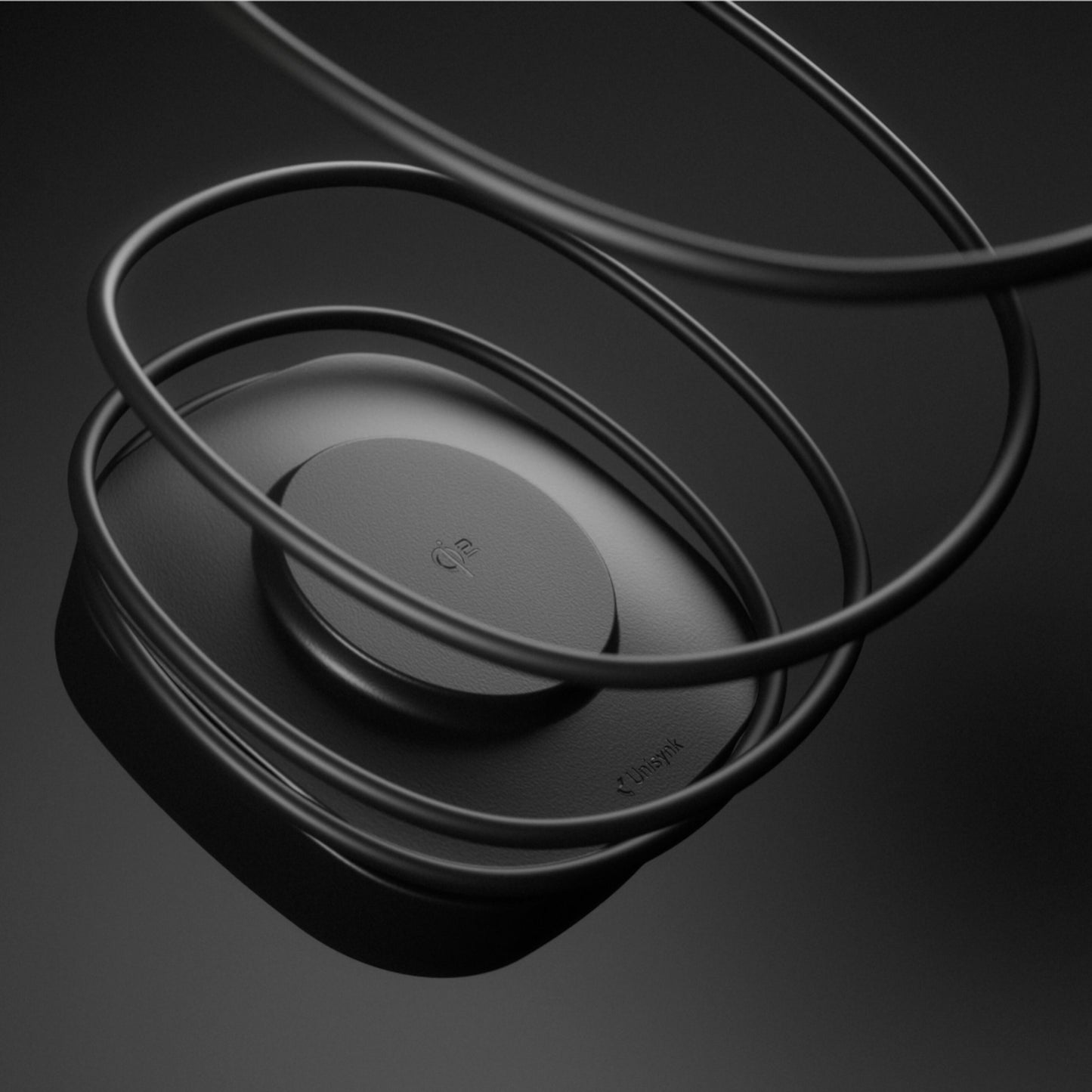 Unisynk USB-C/Qi2 2i1 80W sort trådløs opladeplade, cirkulær med tynde buede ledninger, USB-C kompatibel.