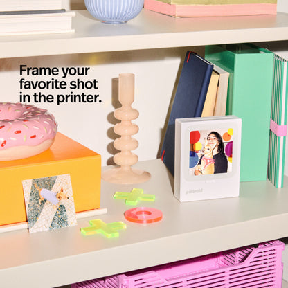 Polaroid Hi-Print 3-3 bærbar fotoskriver inkl. 60 ark ses med printet foto og teksten "Indram dit yndlingsbillede i printeren.