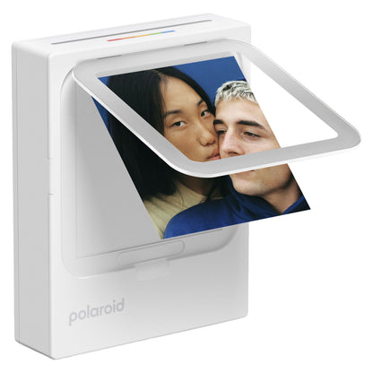 Polaroid Hi-Print 3x3 foto printer i hvid printer billede af to personer, blå baggrund synlig.