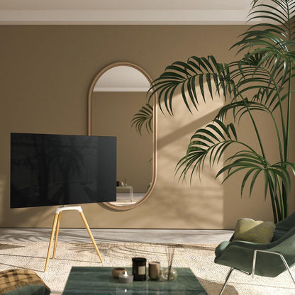 Fladskærms-tv på TV gulvstand skandinavisk design (50-65", 35 kg), beige væg, ovalt spejl, grøn lænestol, plante.