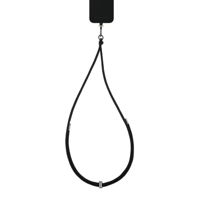 Sorter smartphone med IDEAL OF SWEDEN Cord Phone Strap justerbar mobilrem med metalspænder, hænger lodret.