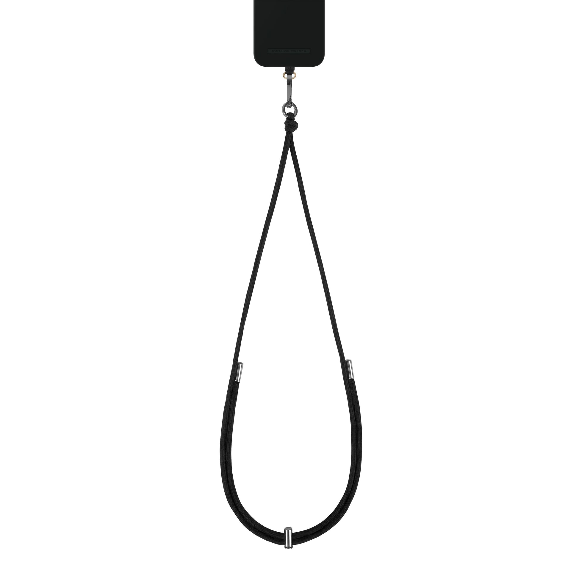 IDEAL OF SWEDEN Cord Phone Strap sort cover med justerbar rem i metaldetaljer, løkke til at bære mobilen om halsen.