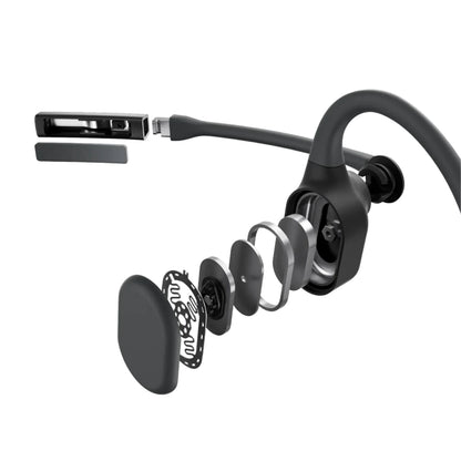 Shokz OpenComm2 trådløse hovedtelefoner eksploderet visning med synlige højttaler, mesh, mikrofon og indre lag.