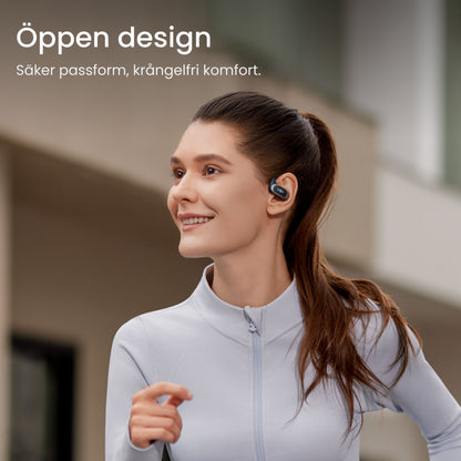 Shokz OpenFit Air trådløse øretelefoner sort bæres af kvinde udendørs svensk tekst: Öppen design Säker passform.