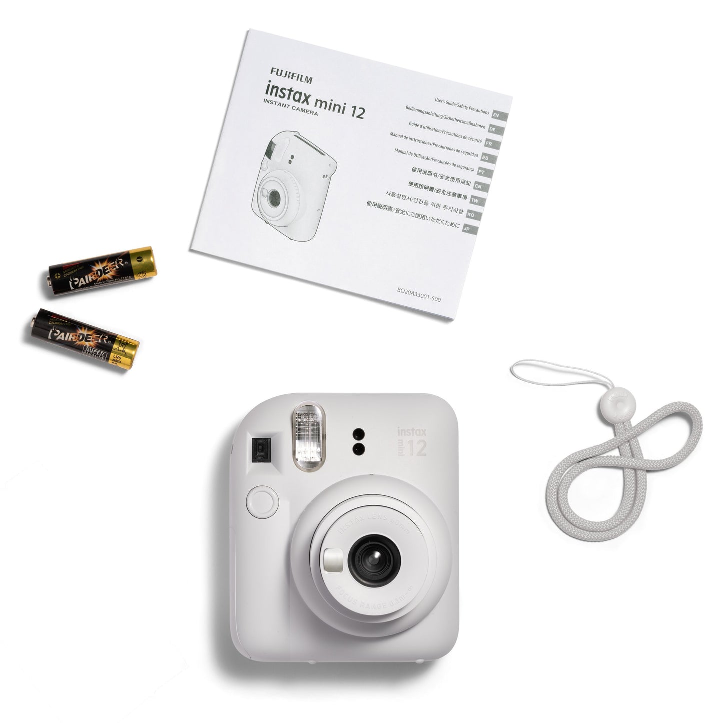 Fujifilm Instax Mini 12 kamera hvid med to AA-batterier, rem og brugervejledning.