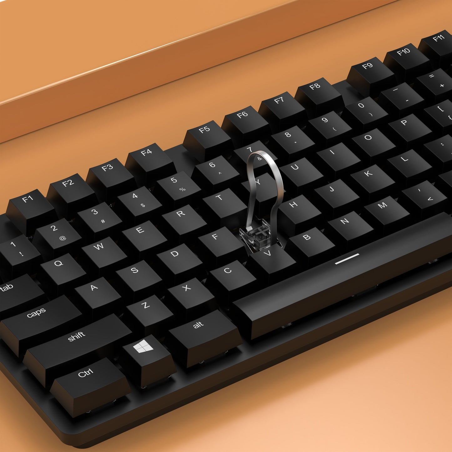 Sort tastatur med keycap puller på orange overflade ved siden af Luxorparts 20-i-1 rengøringskit.