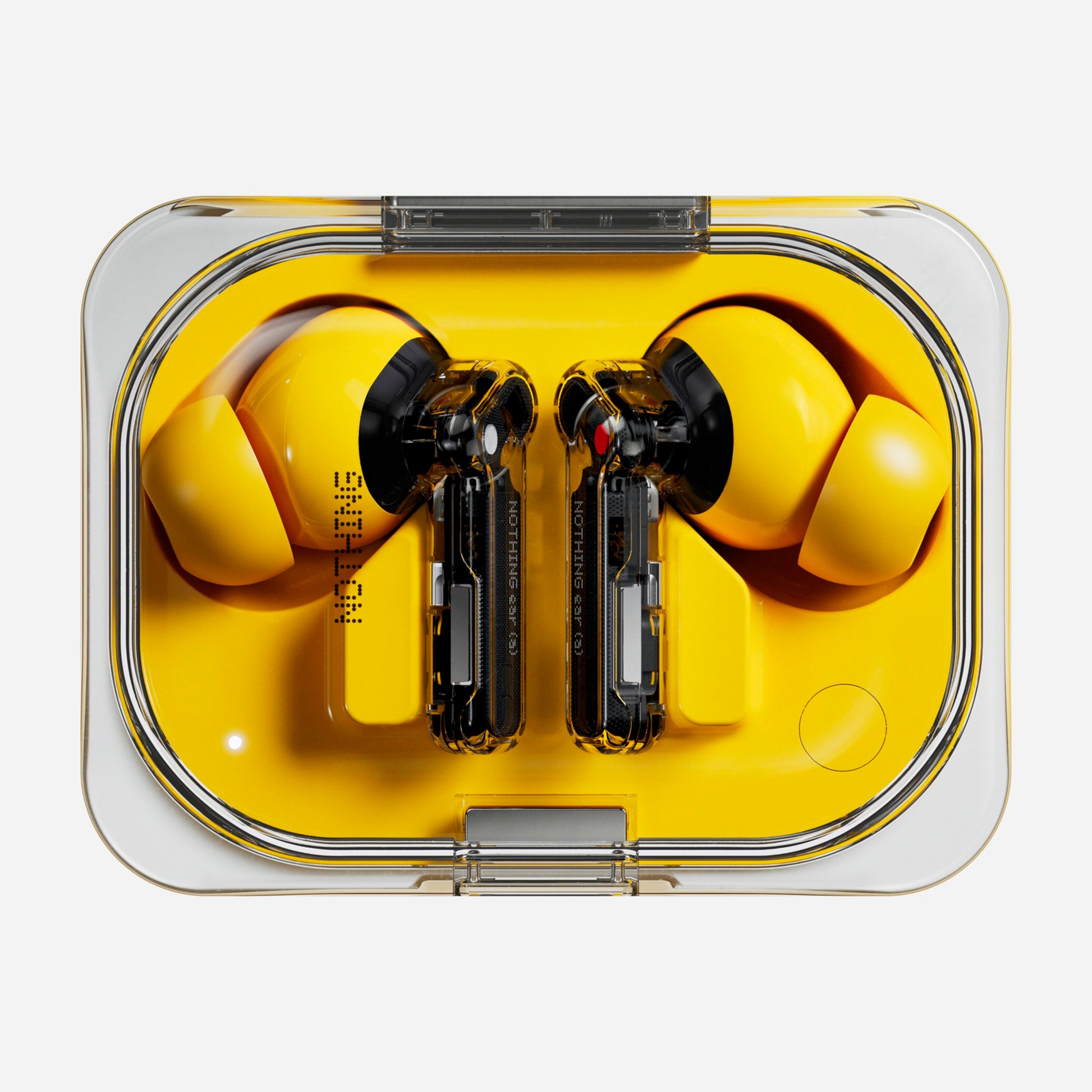 Nothing Ear (a) gul/sort in-ear høretelefoner med synlige indvendige komponenter i gennemsigtigt rektangulært etui.