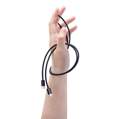 Linocell flettet USB-C 2.0 kabel 240 W sort 2 m viklet løst om hånd med strakte fingre.