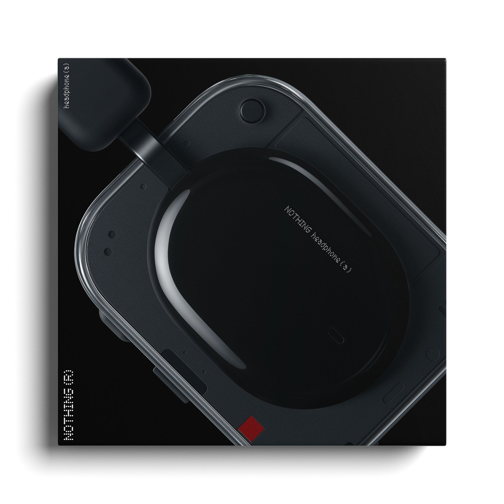 Nothing Headphone (a) sorte trådløse over-ear hovedtelefoner set ovenfra på sort æske med hvid tekst og gennemsigtigt etui.