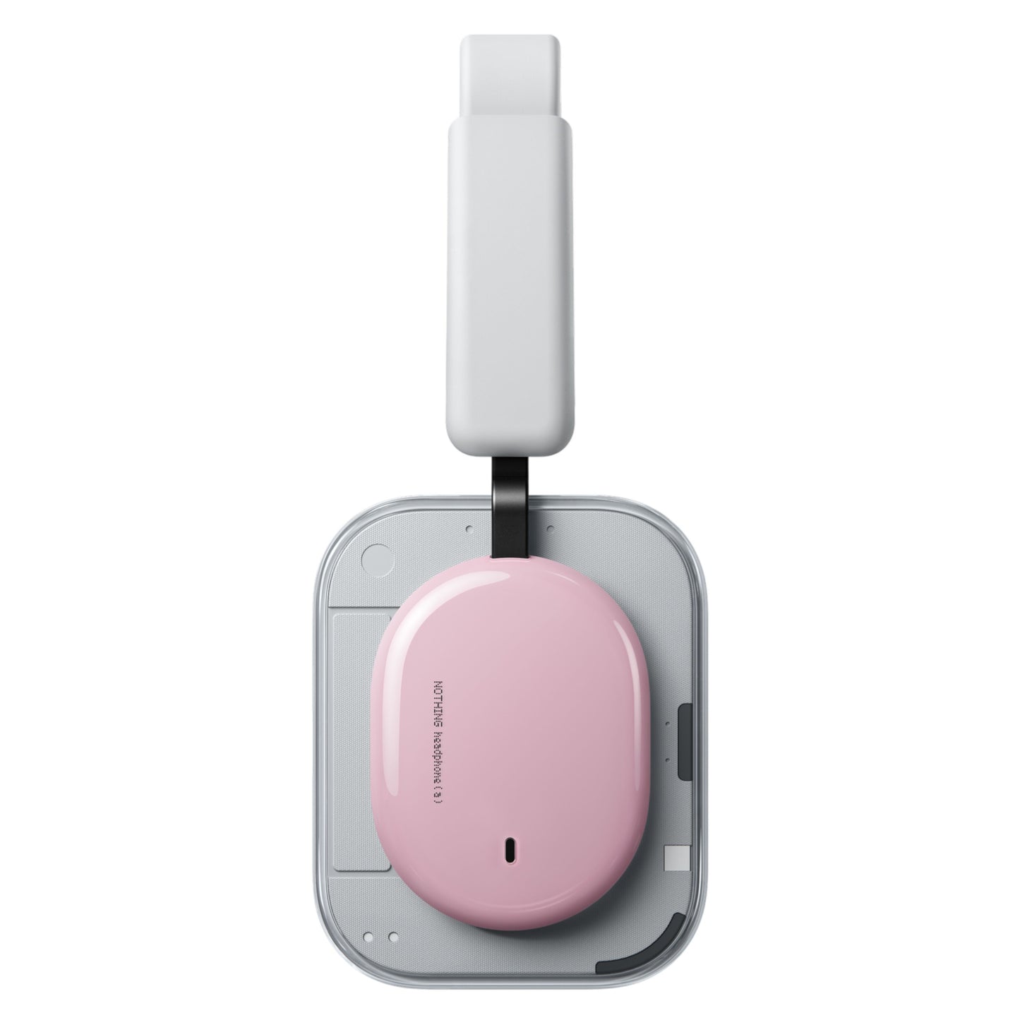 Nothing Headphone (a) trådløse over-ear høretelefoner rosa ved siden af lyserød oval enhed på grå trådløs oplader.