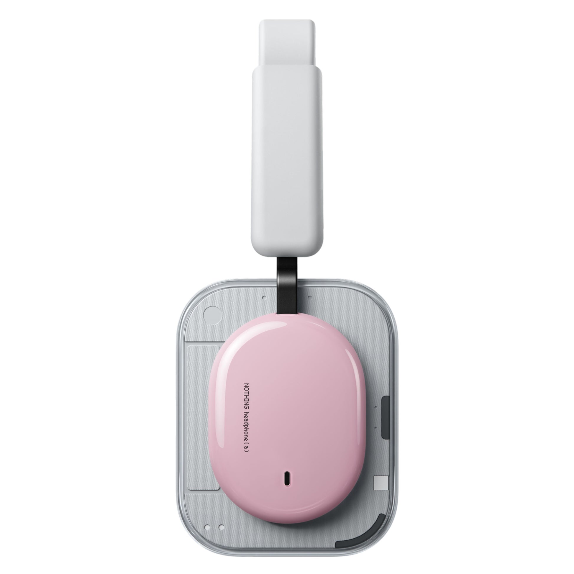 Nothing Headphone (a) trådløse over-ear høretelefoner rosa ved siden af lyserød oval enhed på grå trådløs oplader.