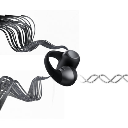 Shokz OpenDots One trådløse åbne clip-on høretelefoner sort set med bølgende metalliske mønstre omkring.