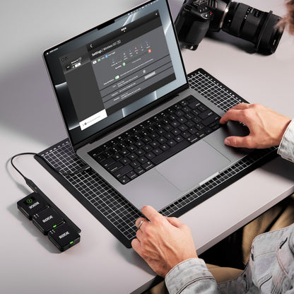 Røde Trådløst GO Gen 3 mikrofonsystem tilsluttet MacBook via USB, DSLR kamera synligt på bordet.