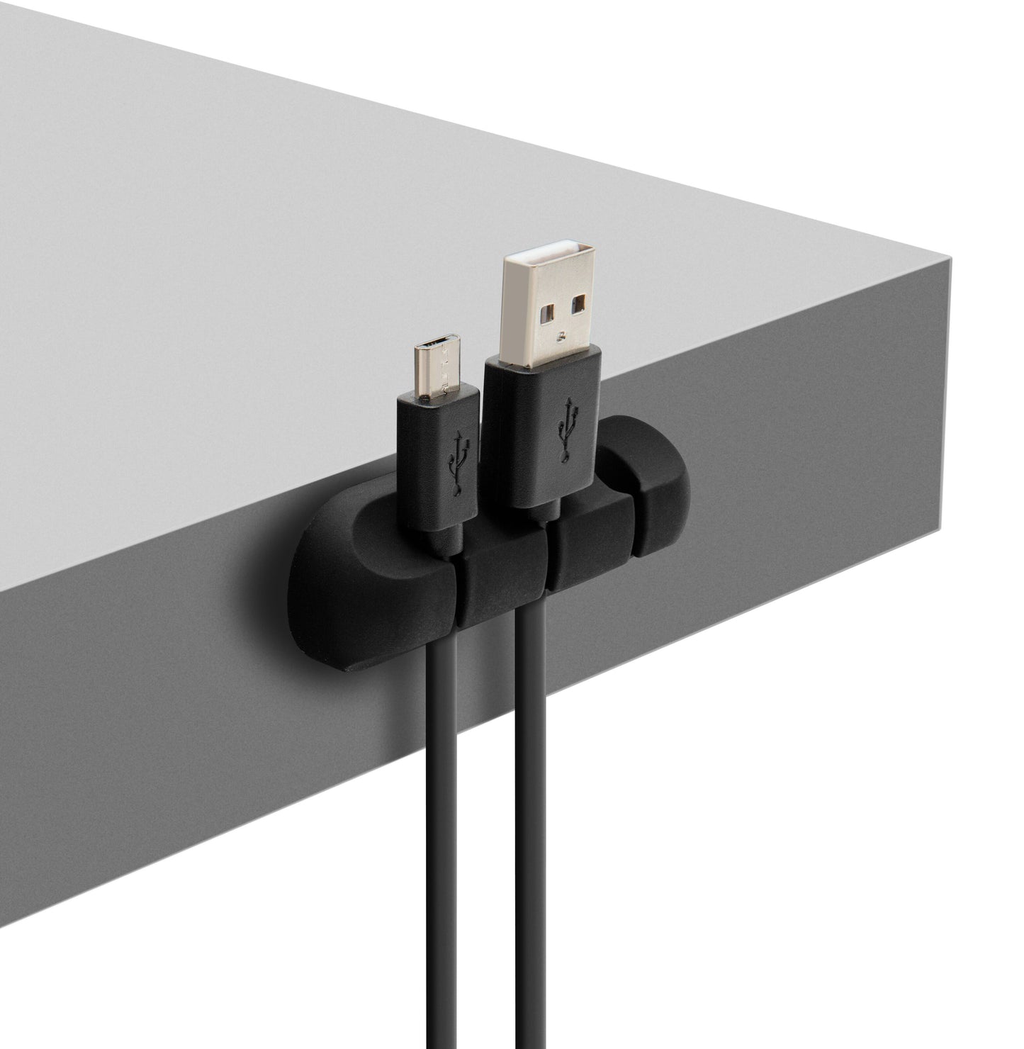 Selvklæbende kabelholder sorterer organiserer USB og micro USB-kabler ved kanten af gråt bord.