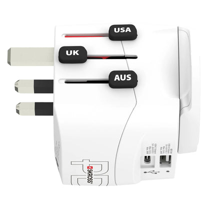 Skross Universal rejseadapter Jordet med USB, markering for UK/USA/AUS stik (delvist ude), til synlige USB-porte på siden.