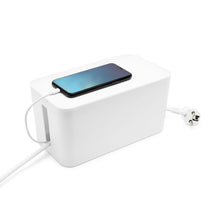 Sort smartphone oplades på hvid Luxorparts Kabelskjuler Mini med strømledning synligt trukket ud til siden.