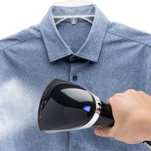 Rubicson tøjdamper fjerner folder fra blå button-up skjorte på bøjle med synlig damp mod stoffet.