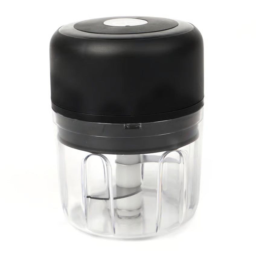 Trådløs mini-hakker til grøntsager og frugt, sort/gennemsigtig plast, cylindrisk form, synlig klinge, trykknap på toppen.