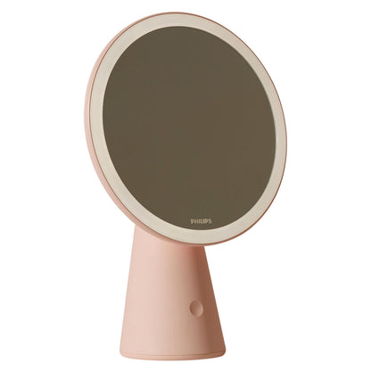Philips Makeup spejl, rundt lyserødt design med LED-lys langs kanten og EyeComfort, Philips logo nederst.
