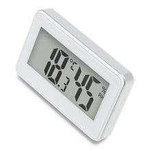 Digitalt termometer og hygrometer med hvid ramme, 45 % luftfugtighed og 18,2 °C vises på rektangulært display.