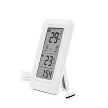 Rubicson termometer med hvid ramme, viser 29°C ude, 23°C inde, tid 1:54 og har tilsluttet kabelsensor.