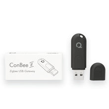 Sort Conbee II Zigbee USB-controller uden hætte ved siden af æske markeret med Conbee II Zigbee USB-Gateway.