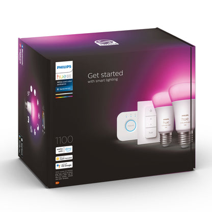 Philips Hue Color Ambiance startpakke æske med 2 LED-pærer, Hue Bridge og lysdæmper, lilla/sort emballage med smart-home ikoner.