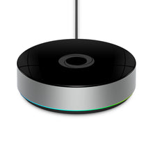 Athom Homey Bridge smart home-controller, rund, sort blank top, sølv sider, farvet lysring, kabel bagtil.