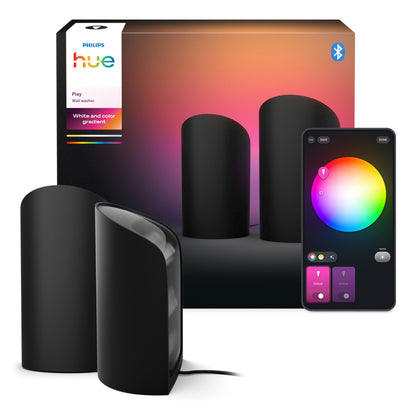 Philips Hue Spil Wall Washer væglampe 2-pak sort med farverig æske og smartphone med lysstyringsapp vises.