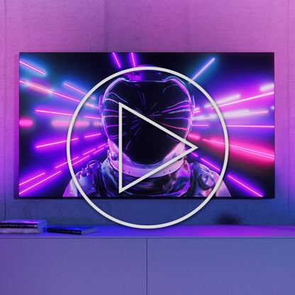 Philips Hue Spil Wall Washer Væglampe 2-pak sort vises på tv-skærm med lys og play-knap midt på billedet.