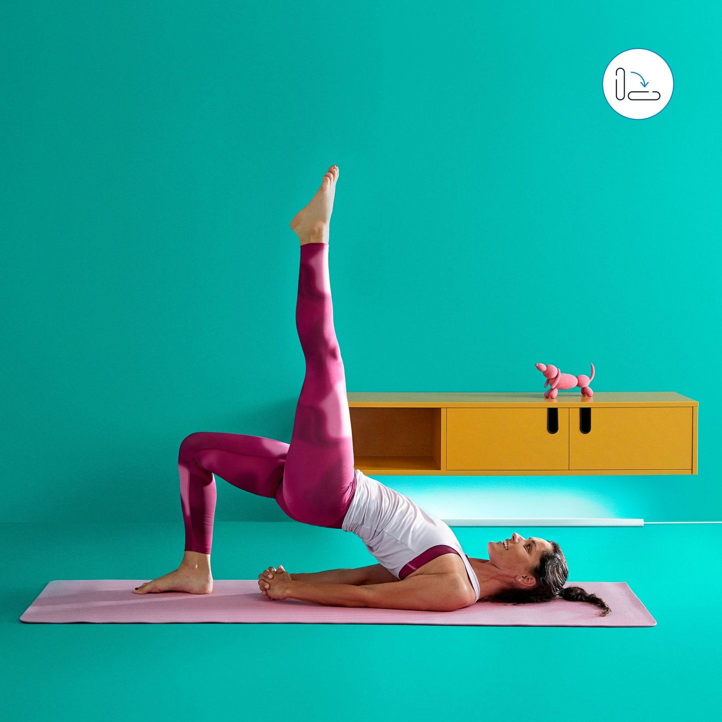 WiZ Stolpe Gulvlampe smart belysning i rum med turkise vægge, gul hylde, lyserød yogamåtte og hundefigur.