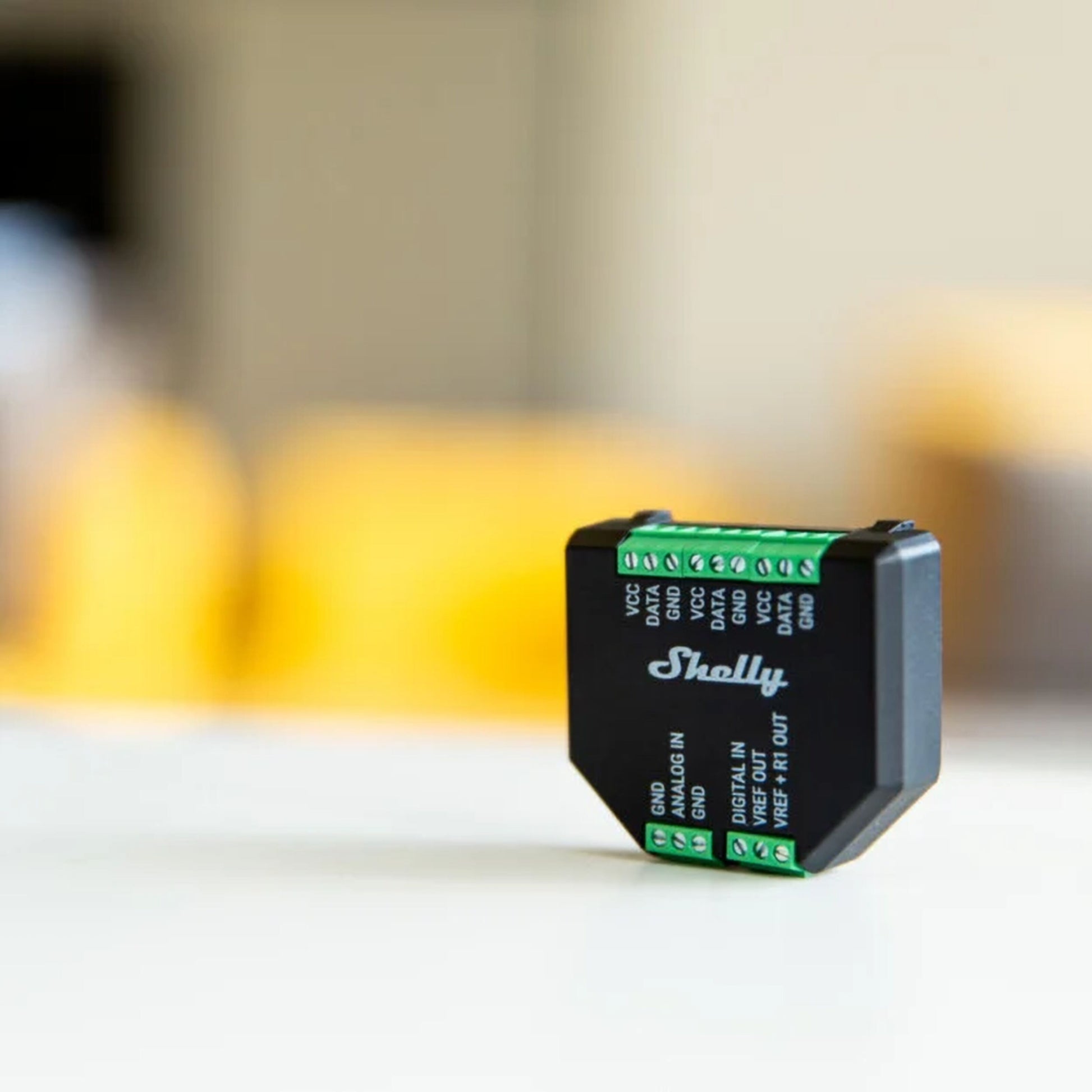 Shelly Tillæg Plus sorterer kompakt enhed med grønne ledningsterminaler velegnet til smart home og temperaturmåling.