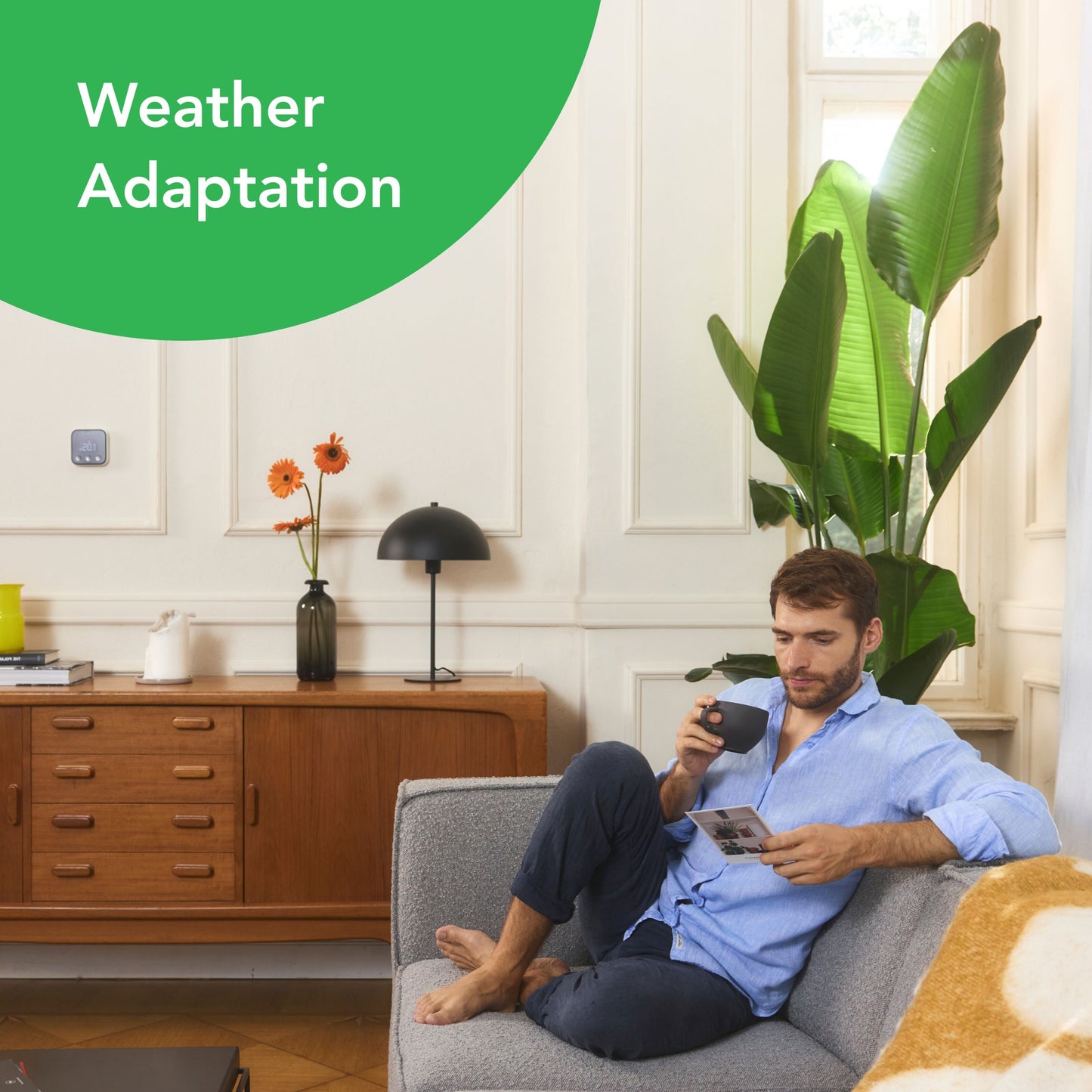 Tado Smart termostat X trådløs med "Weather Adaptation" vises aktiveret på display, placeret i lys stue.