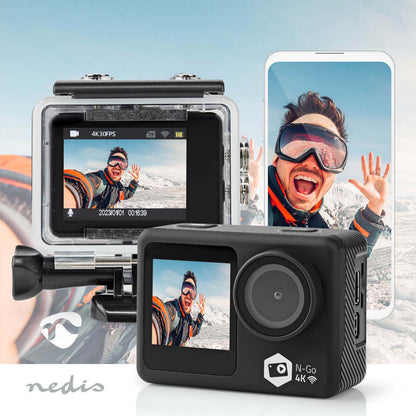 Nedis 4K actionkamera med to skærme, display viser selfie i sne med skibriller, billede spejlet på smartphone, Nedis-logo.