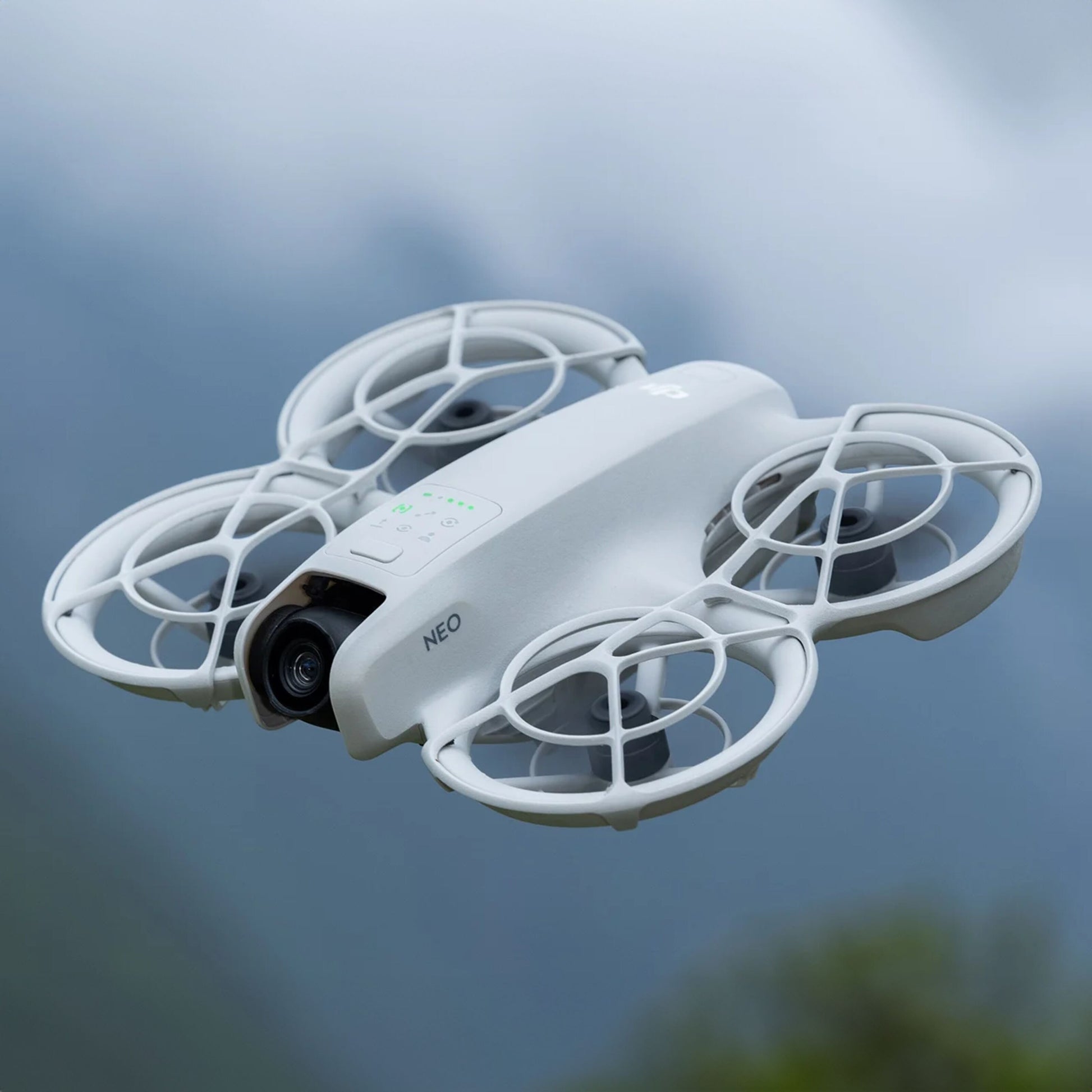 DJI Neo Motion Fly More Combo quadcopter drone med propelbøjler og NEO-logo, udendørs, 4K kamera.