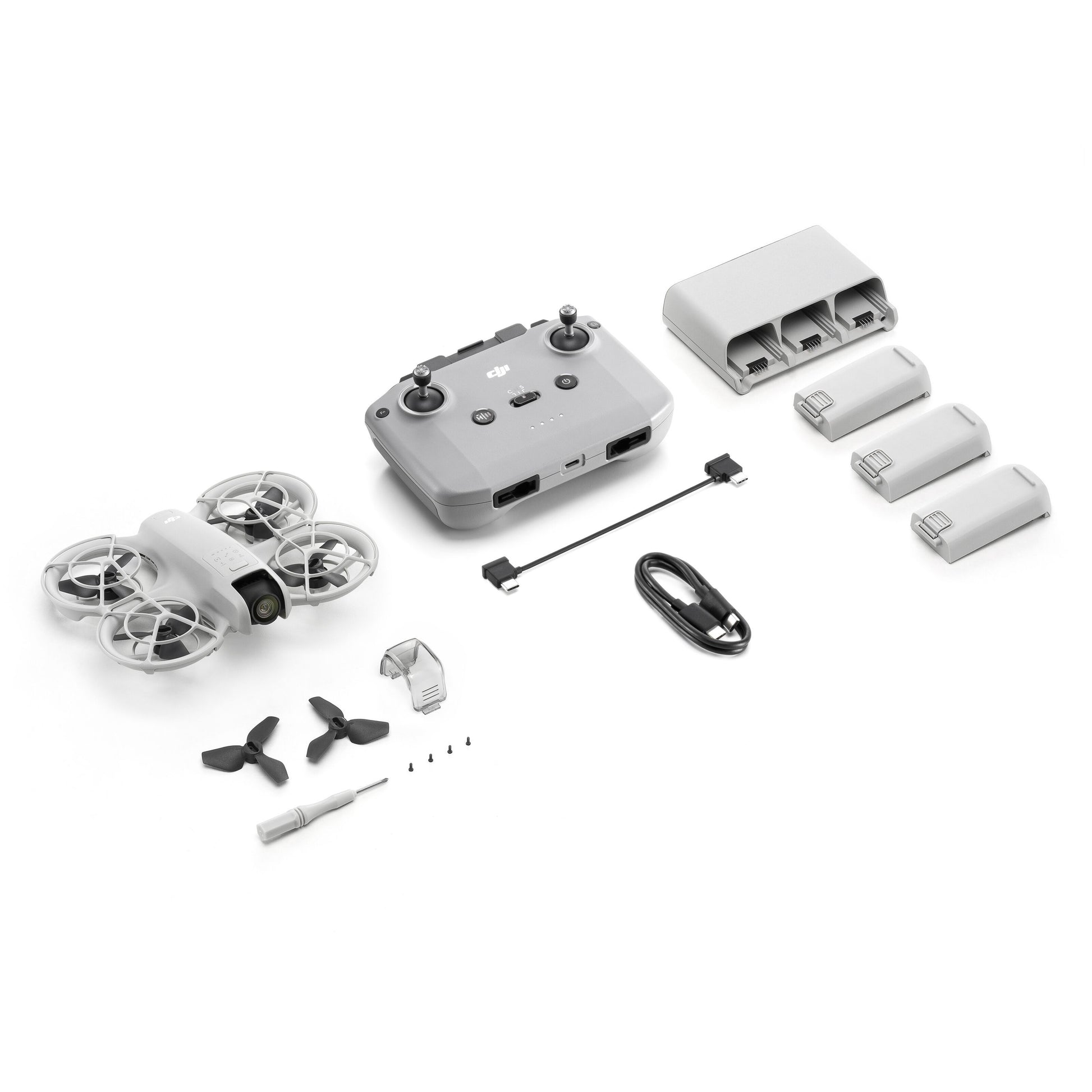 DJI Neo Fly More Combo ultrakompakt drone med controller, ladestation, 3 batterier, kabler, propel og værktøj.