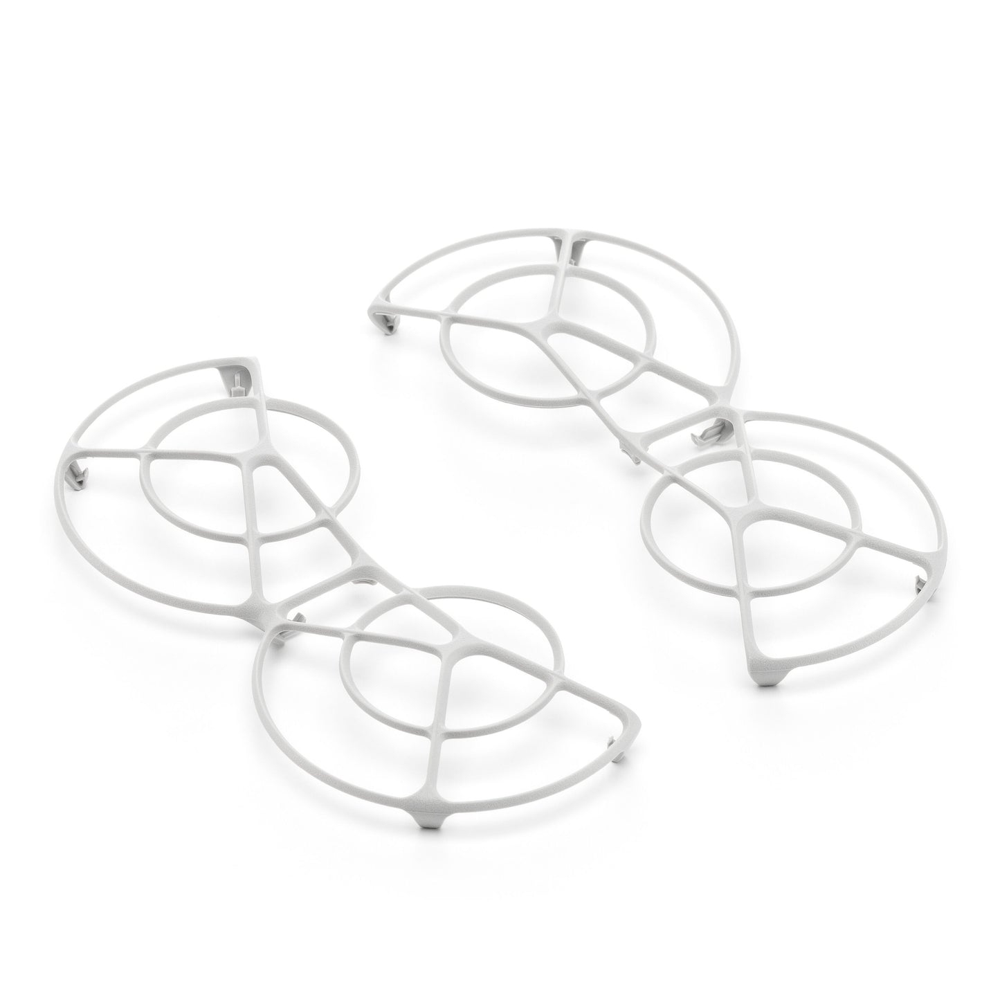 Dji Neo Rotorbeskyttelse-inspirerede hvide metalbordskånere med cirkulære og buede geometriske mønstre.
