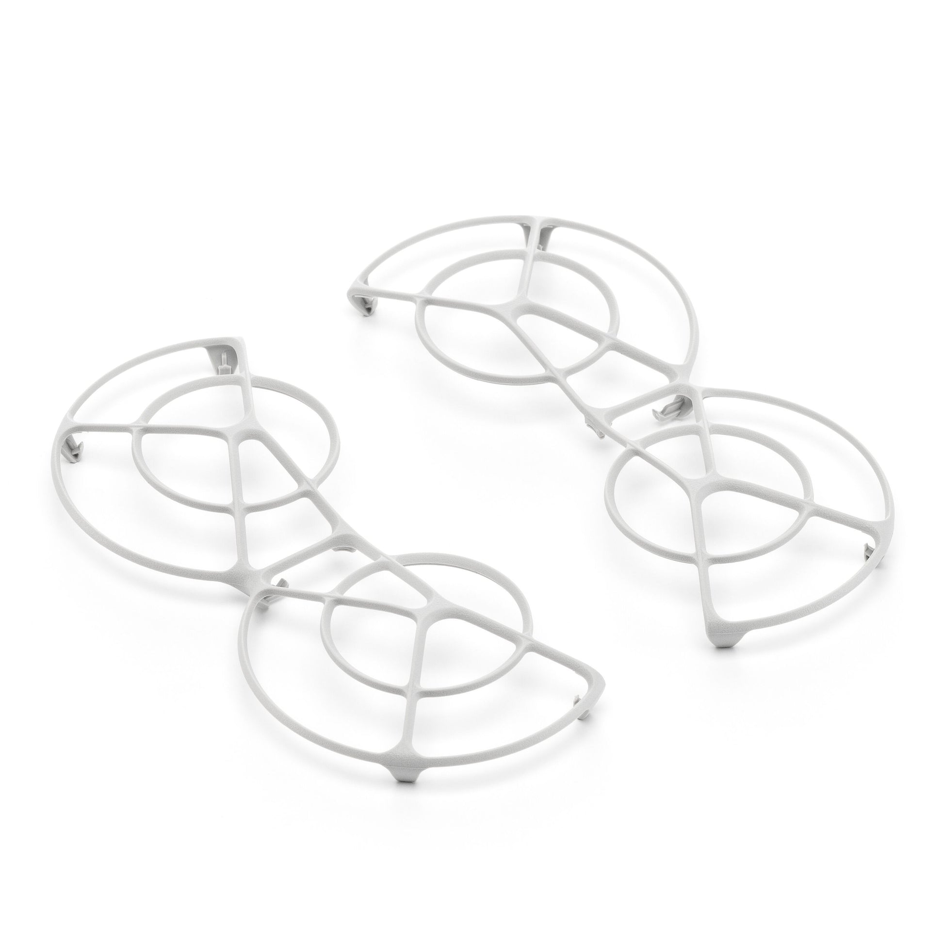 Dji Neo Rotorbeskyttelse-inspirerede hvide metalbordskånere med cirkulære og buede geometriske mønstre.