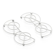 Dji Neo Rotorbeskyttelse-inspirerede hvide metalbordskånere med cirkulære og buede geometriske mønstre.