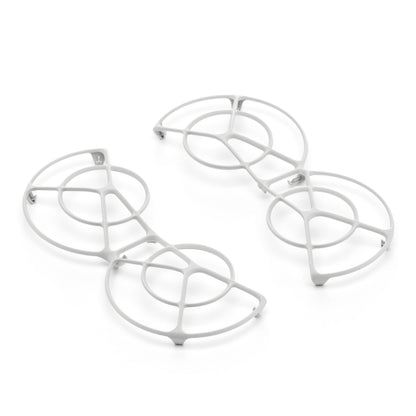 Dji Neo Rotorbeskyttelse-inspirerede hvide metalbordskånere med cirkulære og buede geometriske mønstre.