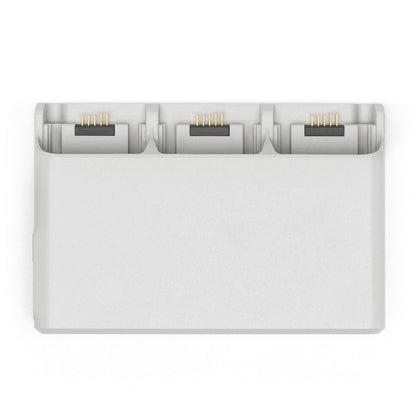 DJI Neo opladningsstation med tre slots og guldkontakter til DJI Neo-batterier.