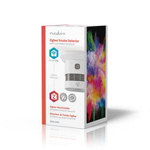Nedis WiFi brandalarm 5 år, hvid, på emballage med farverigt grafisk motiv og SmartLife/WiFi-integration ikoner.