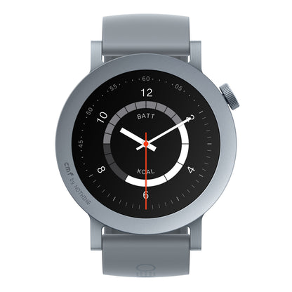 Nothing CMF Watch Pro 2 smartwatch askegrå, rund urskive, analog visning 6:05:23, sideknap, "BATT" og "KOAL" på skiven.