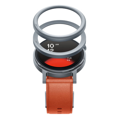 Intet CMF Watch Pro 2 Orange i eksploderet visning med runde komponenter og AMOLED-skærm, der viser tid og dato.