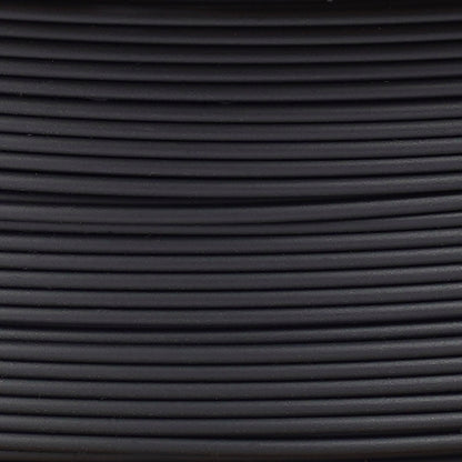 Copymaster3D PLA-filament 1,75 mm sort ruller, tæt oprullede og arrangeret vandret med synlige lys- og skyggeeffekter.