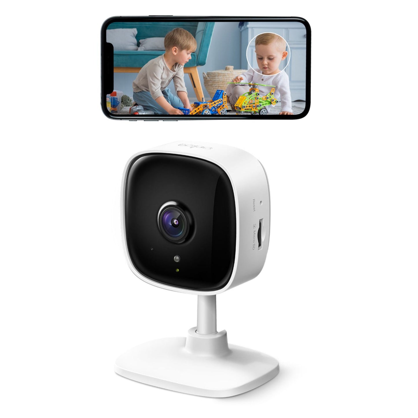 TP-Link Tapo C100 trådløst overvågningskamera vist under smartphone med live-billede af børn, der leger på gulvet.