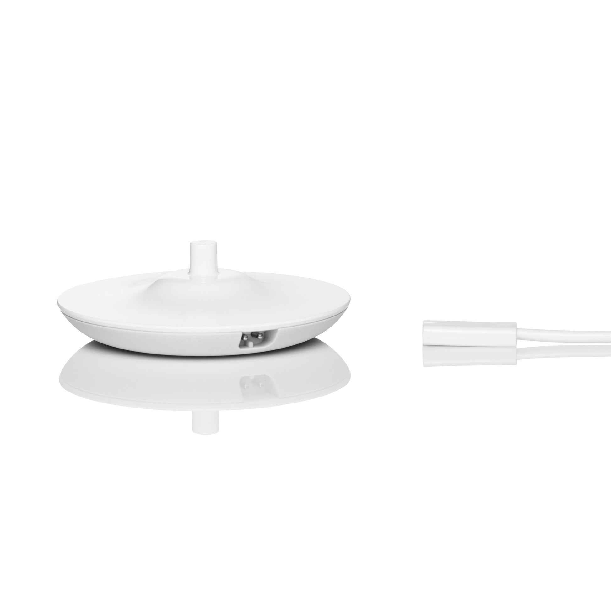 Jordan Clean Smile Plus elektrisk tandbørste, hvid, rund form med central knop og port, ved siden af hvidt kabel.