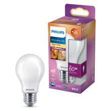 Philips dæmpbar LED-pære E27 806 lm ved emballage med info om 7W, 806 lumen, varmt hvidt lys (2700K), energibesparelse.